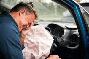 man and airbag after an accident