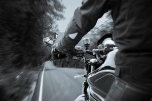 man riding motorcycle on grey day