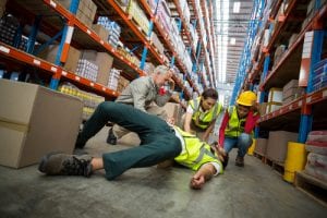 worker hurt and on the floor of warehouse