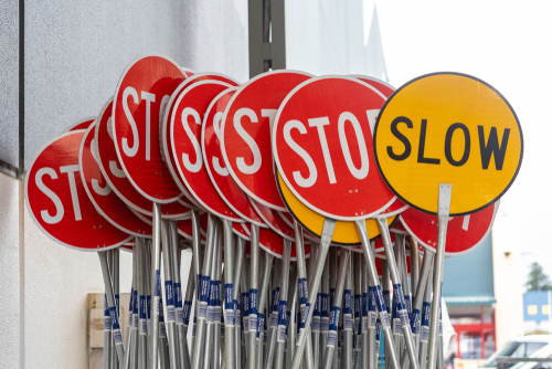a collection of stop and slow signs used for traffic calming in a neighborhood