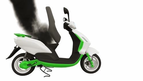 Electric scooter emitting black smoke, illustrating an E-Bike and E-Scooter Battery Fire Injury risk.