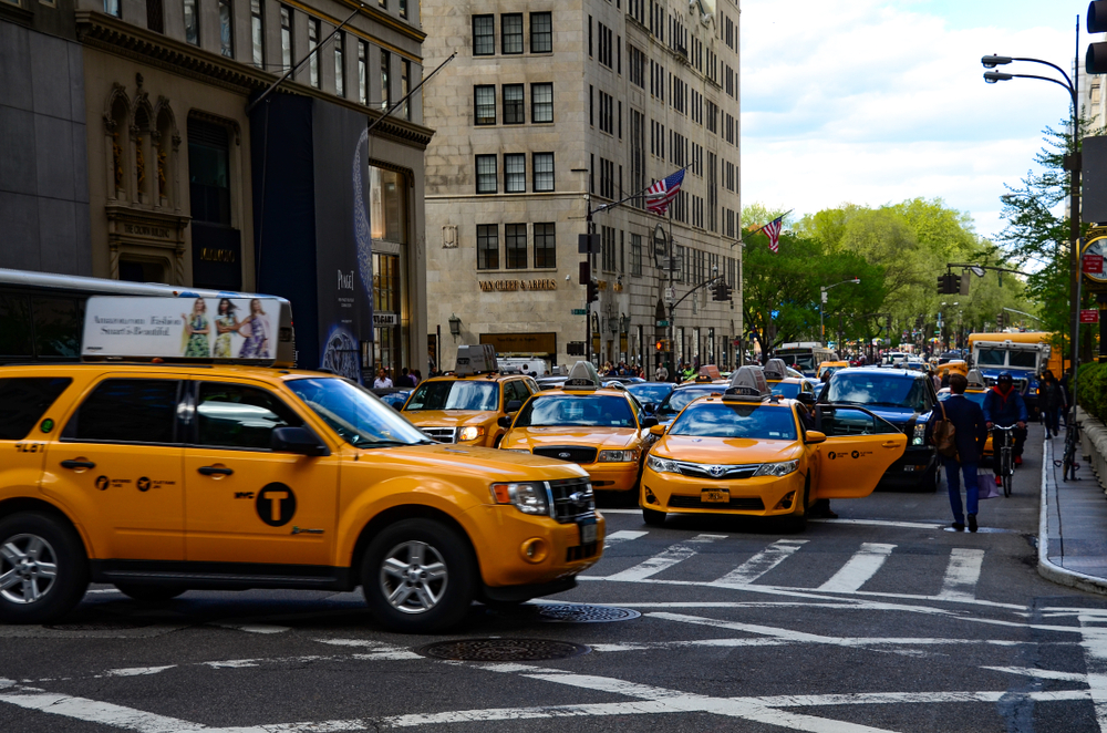 Manhattan, New York City, USA - June 2, 2019 Yellow New York City Taxi is riding in Midtown, Manhattan on a beautiful summer day