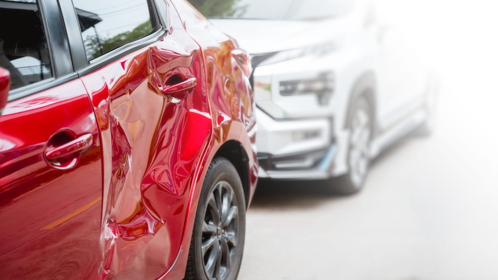 Close-up of car door damage after a New York car accident